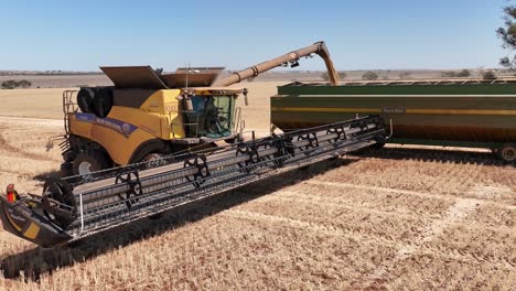 this footage captures the synergy of modern agricultural technology, showcasing the essential role of header fronts in the wheat harvesting process