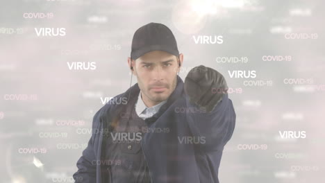 video compuesto digital de texto de covid-19 y células moviéndose contra el hombre apuntando a la cámara en la parte posterior