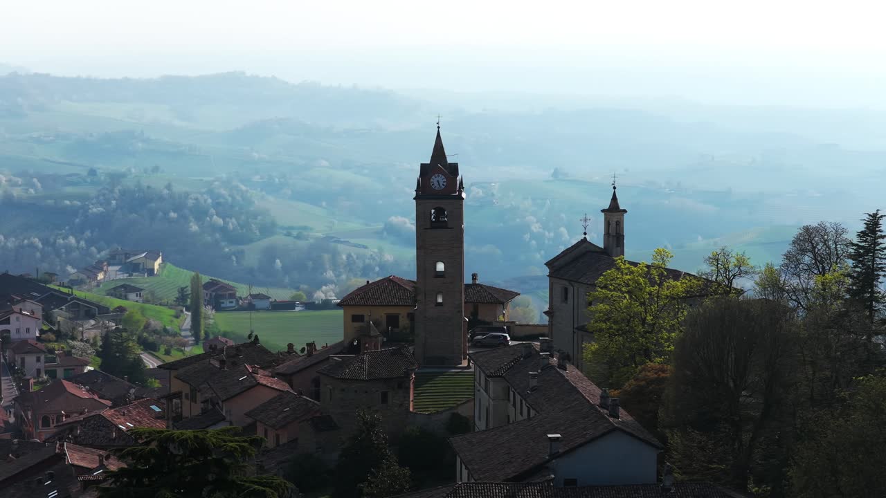 Iconic Clock Tower Of Monforte d'Alba Backdropped By Foggy Landscape In Piedmont, Italy. wide drone shot