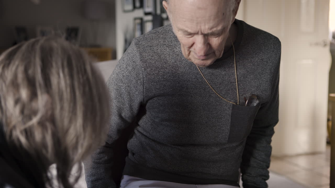 Elderly man at home with family