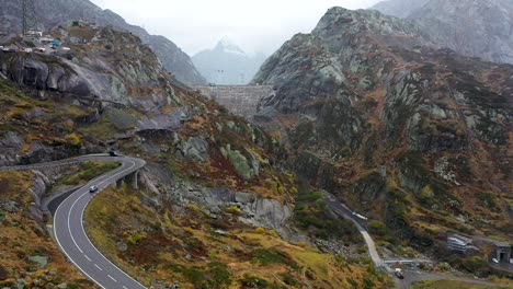 Blick-Auf-Die-Grimselpass-hochalpenstraße,-Autos,-Damm-Und-Schweizer-Alpen-Im-Hintergrund,-Schweiz