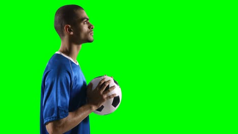 Profile-of-football-player-holding-a-football