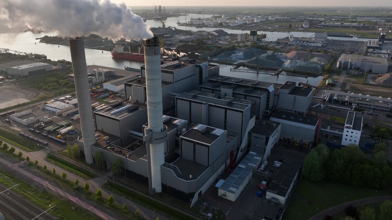Massive waste incinerator, smoke plums, sky view. Aerial view. waste incineration plant, sunset. Aerial view.