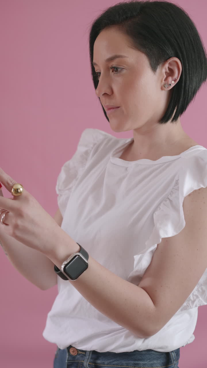 Modern woman intently observing her smartphone screen while interacting with it.