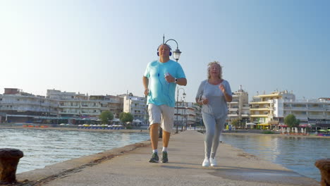 couple in headphones having a run