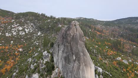 aerial - drone flies in a circular arc around sugarloaf rock in the town of kyburz ca, aftermath of a wildfire can be seen