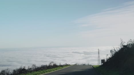 Car-View-of-Driving-Scenic-Road-Above-Clouds-at-Sunset