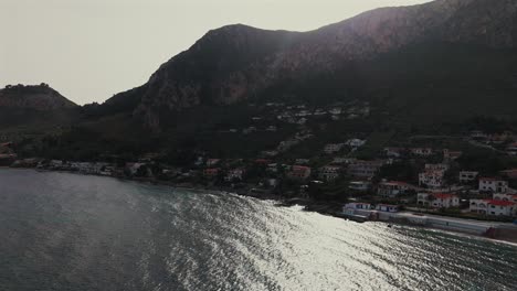 slow motion aerial footage shows sparkling water and hillside houses along the tyrrhenian coast near sant elia and capo zafferano close to palermo in sicily