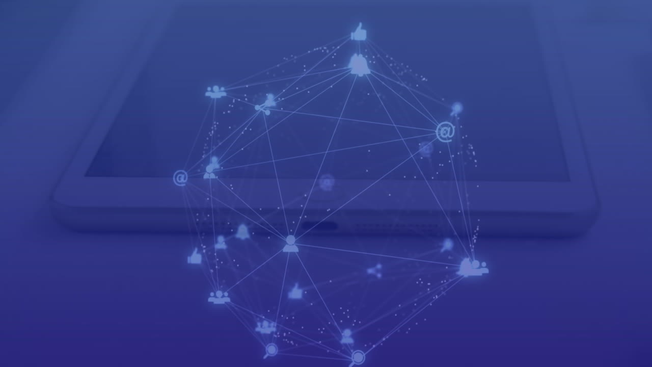 Animation of connected dots forming globe over overhead view of digital tablet and laptop on table