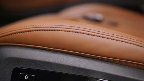 close view of leather interior of luxury car, beige. comfortable perforated seats in business sedan for comfortable ride.