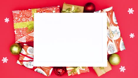 christmas gifts, ornaments and snowflakes appear around frame for text. stop motion