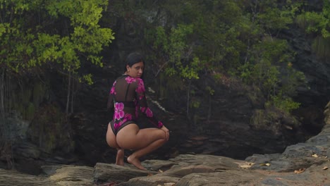 the caribbean offers a stunning view of a latin girl in lingerie on a cliffside beach.