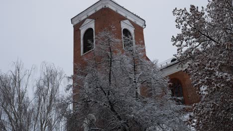 Kaunas-Cathedral-tower-through-snowy-trees-in-cold-winter-day