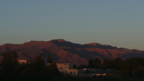 time lapse of changing light conditions on distant mountains during sunset in a desert