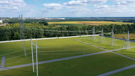 electric transmission towers on a green field. power lines supply with wires. high voltage electric pylons in the countryside.