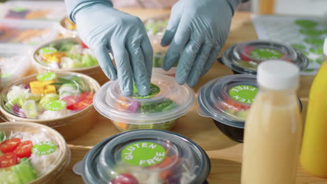 applying eco food sticker on container with healthy meal