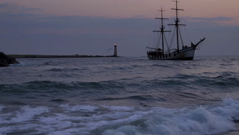 vintage ship and lighthouse at dawn/dusk