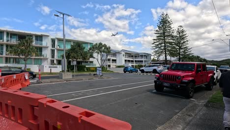 red vehicle navigating roadworks near beach