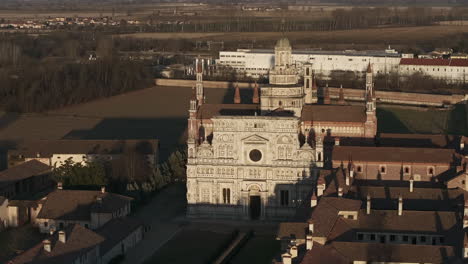 Aerial-shot-of-Certosa-di-Pavia-cathedral-a-historical-monumental-complex-that-includes-a-monastery-and-a-sanctuary