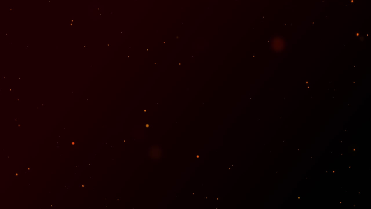 partículas rojas brillantes de luz explotando sobre un fondo negro