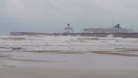 A-view-of-two-big-cruise-with-beach-at-the-port-of-Barcelona-in-Catalonia,-Spain