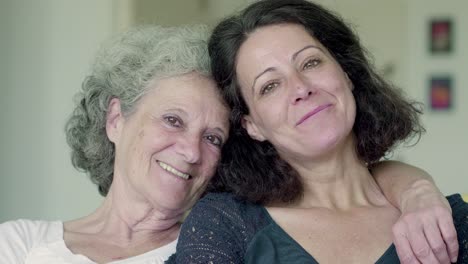 daughter and mother looking at camera, smiling, laughing