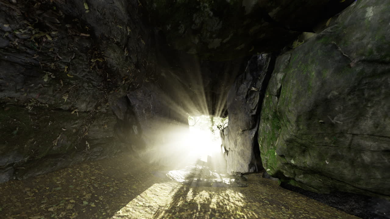 Sunlight streaming through a narrow passage in a rocky landscape at midday