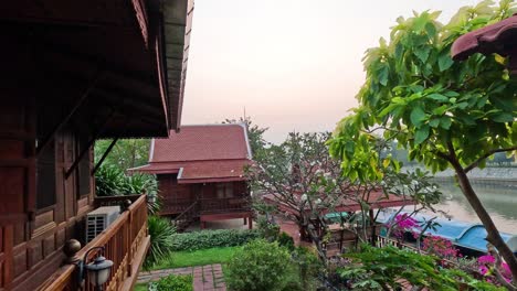 traditional house with lush garden by the river