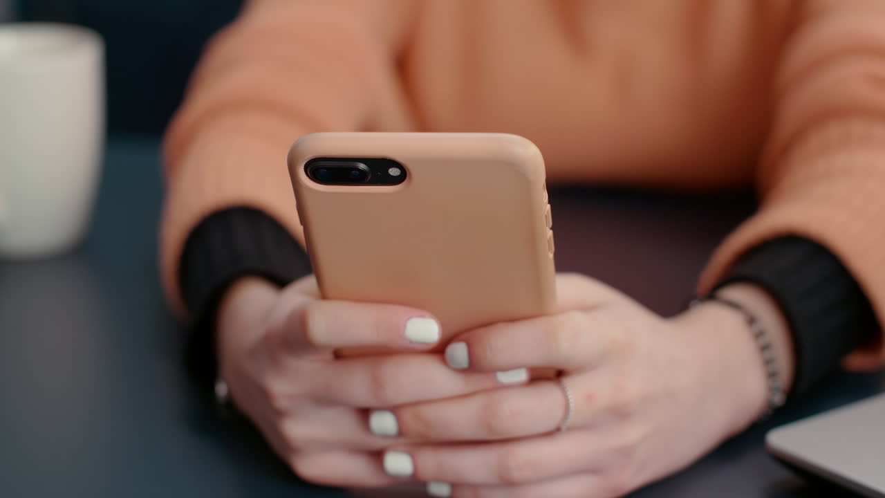 Female student typing on smartphone with touch screen