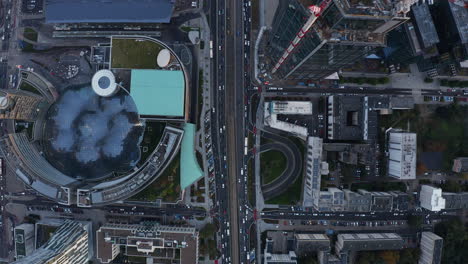 Aerial-birds-eye-overhead-top-down-panning-view-of-streets-and-downtown-buildings.-Heavy-traffic-on-roads.-Warsaw,-Poland