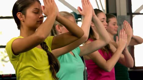 fit group doing yoga in the gym