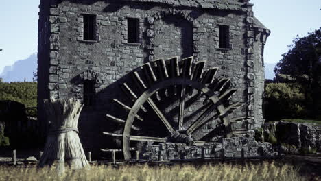 historic water mill in a serene countryside landscape during daylight