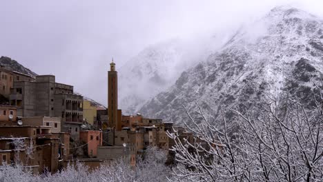 berber village in high atlas mountaines, morocco. snow covered trees