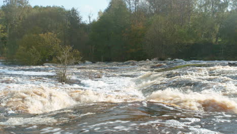 Old powerplant waterfall with powerfull stream