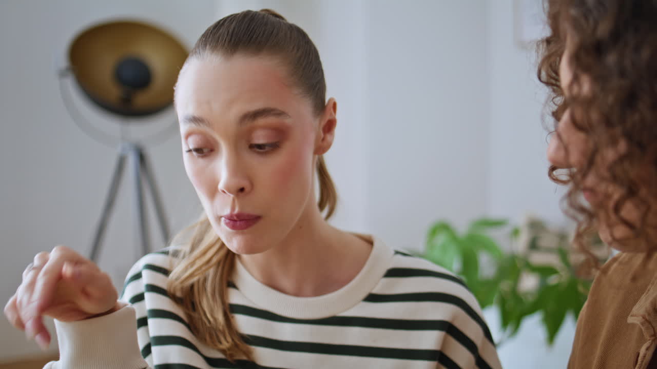Relaxed girl eating grape in kitchen with curly boyfriend closeup. Happy woman