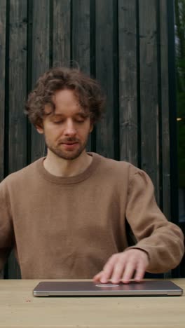 man working on a laptop outdoors