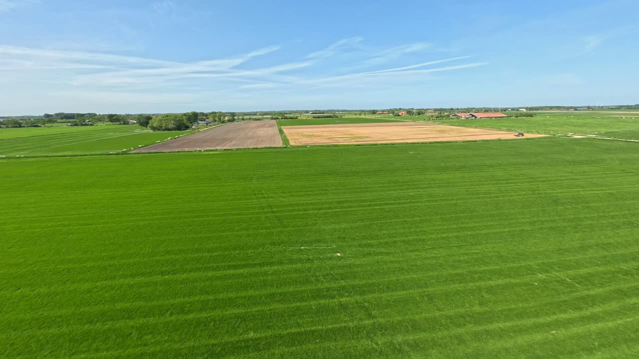 Fast drone shot flying over lush green farm fields near Middelburg, The Netherlands