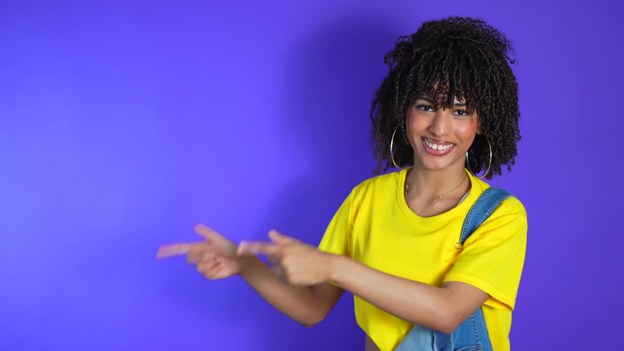 Woman in Yellow Shirt and Denim Overalls Pointing