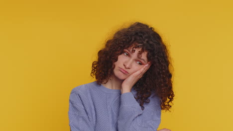 woman with curly hair looking bored