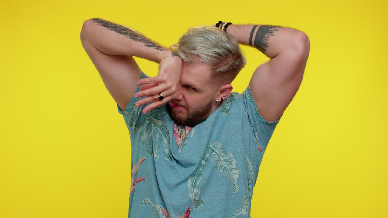 재미있는 관광객 남자가 장난스러운 어리석은 얼굴 표정을 하고, 미소를 짓고, 혀를 보여주며 어리석습니다.