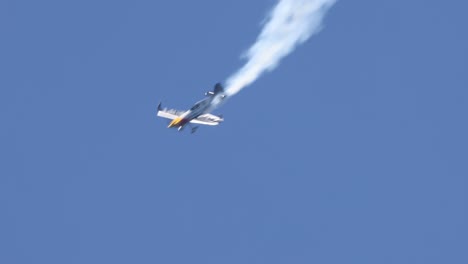 a stunt plane executes complex maneuvers in the sky