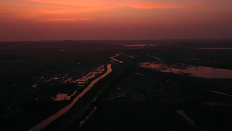 Creek-And-Fields-With-Dramatic-Sky-During-Sunset-In-Vasai,-Mumbai,-India