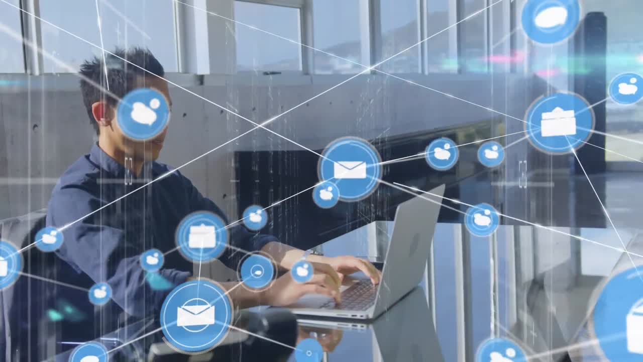 Animation of network of connections with icons over biracial businessman working at office