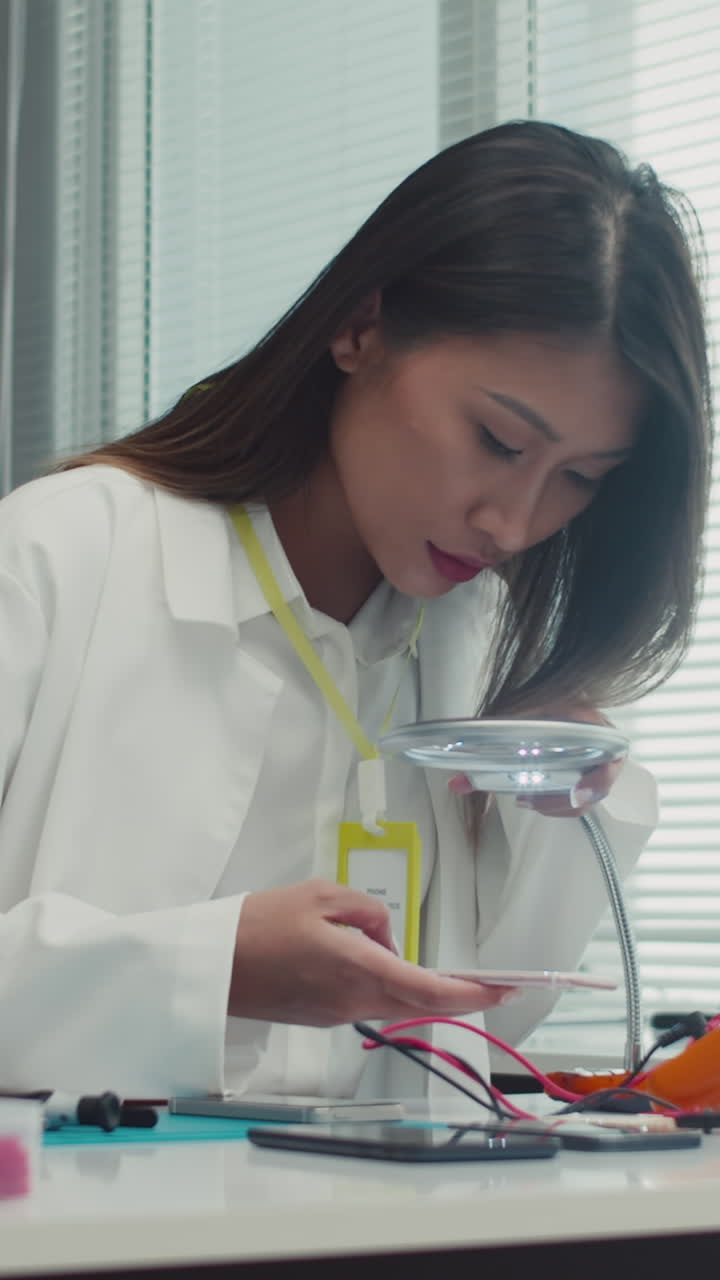Female Specialist Repairing Phone at Service Center