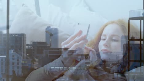 Animation-of-cityscape-over-caucasian-businesswoman-using-smartphone