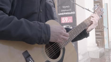 street musician playing acoustic guitar