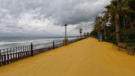 empty sand walkway at the golden mile beach in marbella. empty due to the corona virus