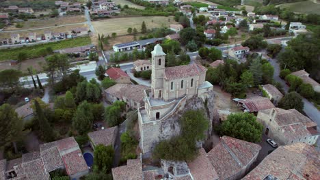 the chapel notre-dame de la consolation, built in 1894 atop a rocky spur overlooking a village in pierrelongue