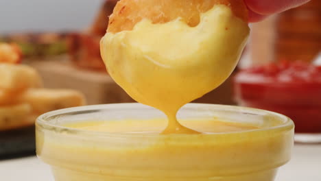dipping chicken nuggets in sauce