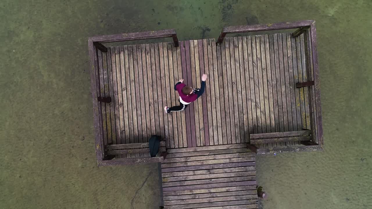 young guy training kickboxing in nature